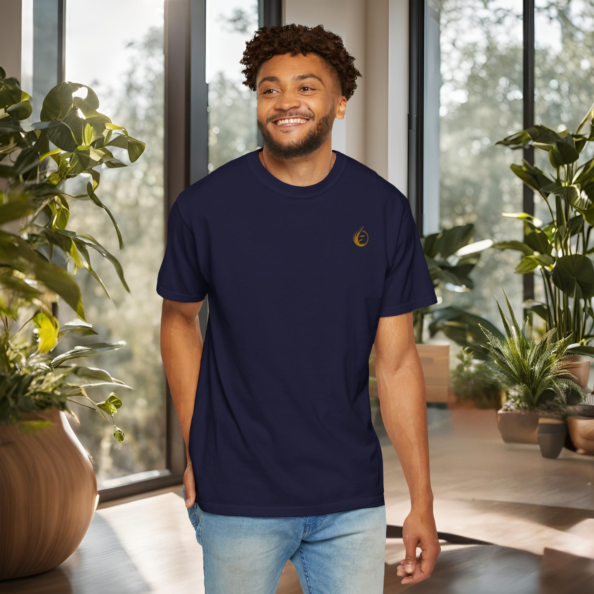 11319985413901526180_2048_customjpeg - Essence Innovation Minimal essential t-shirt. Smiling man in a navy T-shirt stands among indoor plants near large windows.