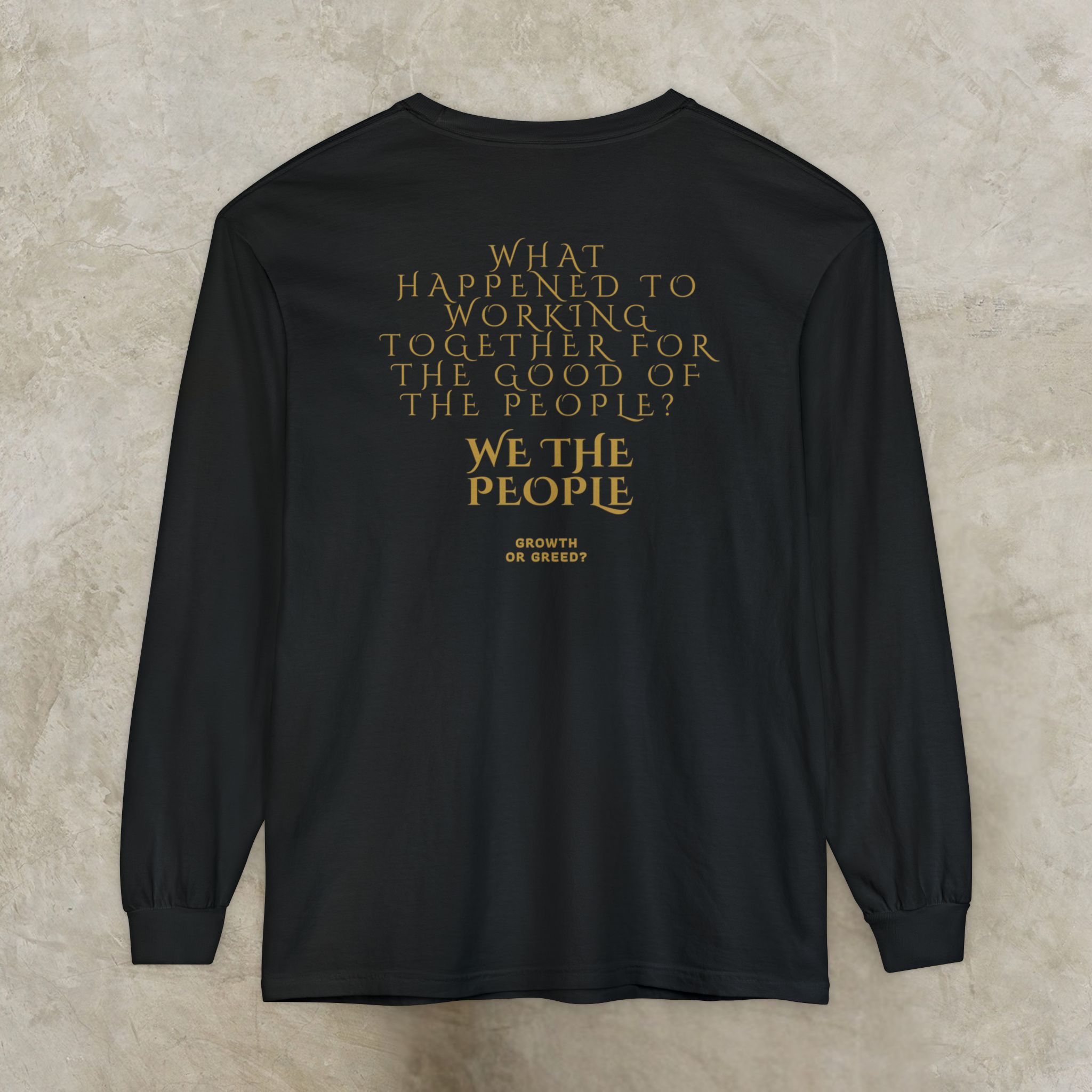 13394960804528226154_2048_customjpeg - Essence Innovation Back view of a black long-sleeve shirt with gold text reading: 'What happened to working together for the good of the people? We the people.' (partially visible)