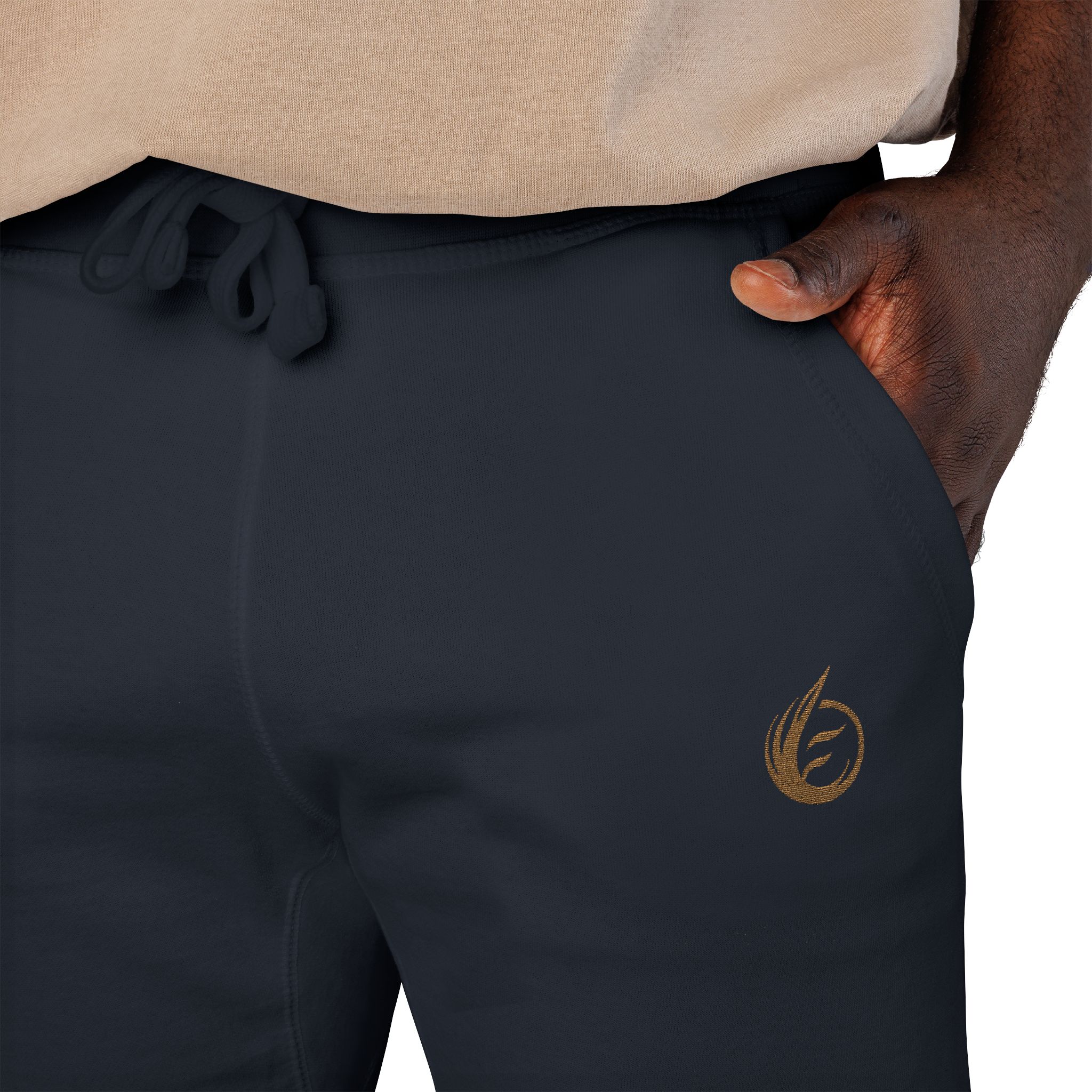 13747137360615665508_2048jpeg - Essence Innovation Close-up of a person wearing a beige knit top and dark drawstring pants, with a hand resting on the hip and a gold emblem on the pant leg at the thigh area.