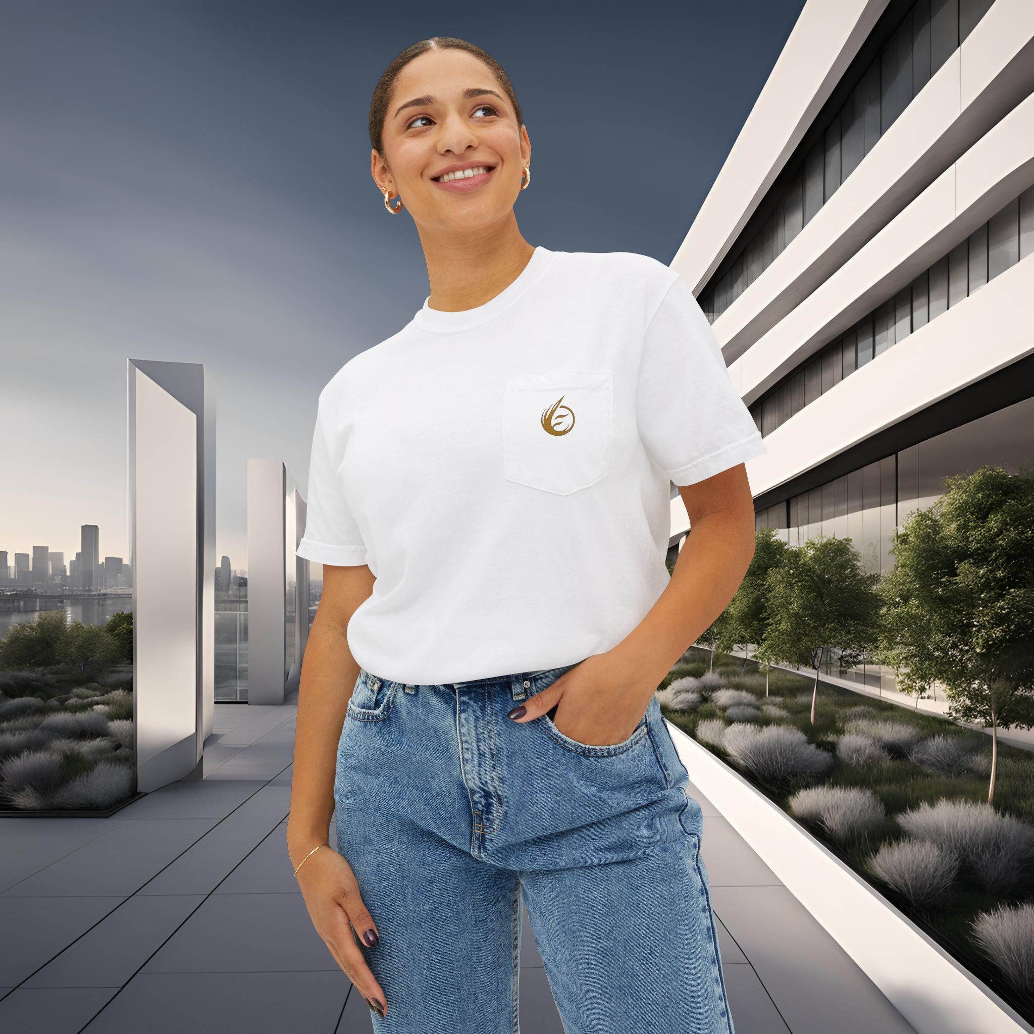 16780728501719478956_2048_customjpeg - Essence Innovation Smiling woman in a white T-shirt with a gold emblem, standing near a modern glass building outdoors. A city skyline is visible in the background.