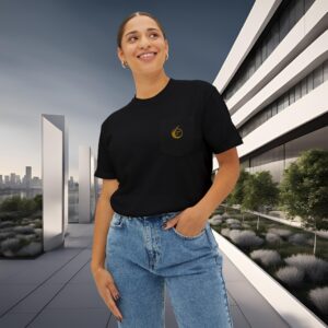 16973340723018337912_2048_customjpeg - Essence Innovation Young woman in a black T-shirt with a gold logo on the pocket, standing near a modern white building in an urban plaza at dusk/dawn.