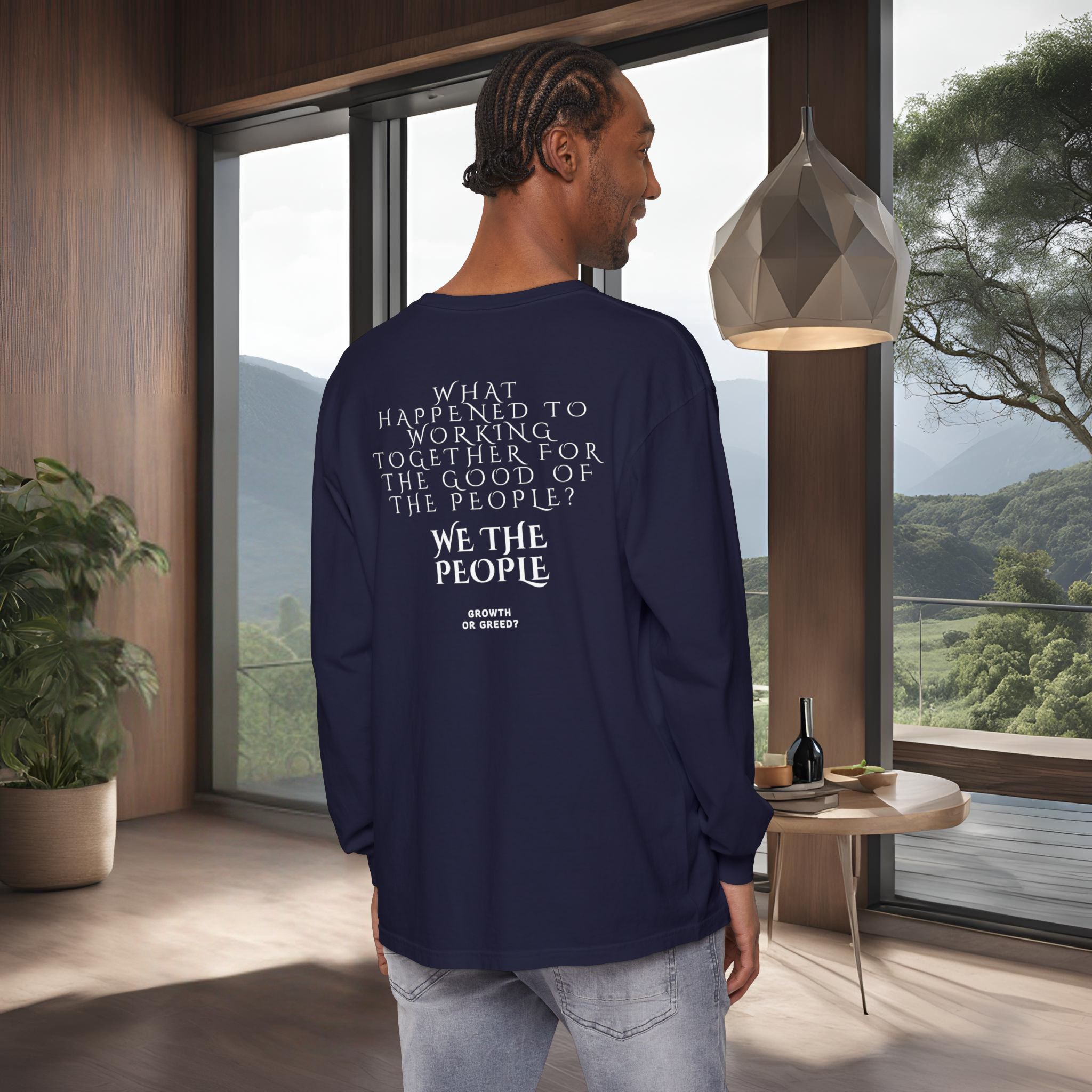 2246805395088898938_2048_customjpeg - Essence Innovation Back view of a person in a navy shirt with the printed message, standing in a modern room with large windows showing mountains outside.
