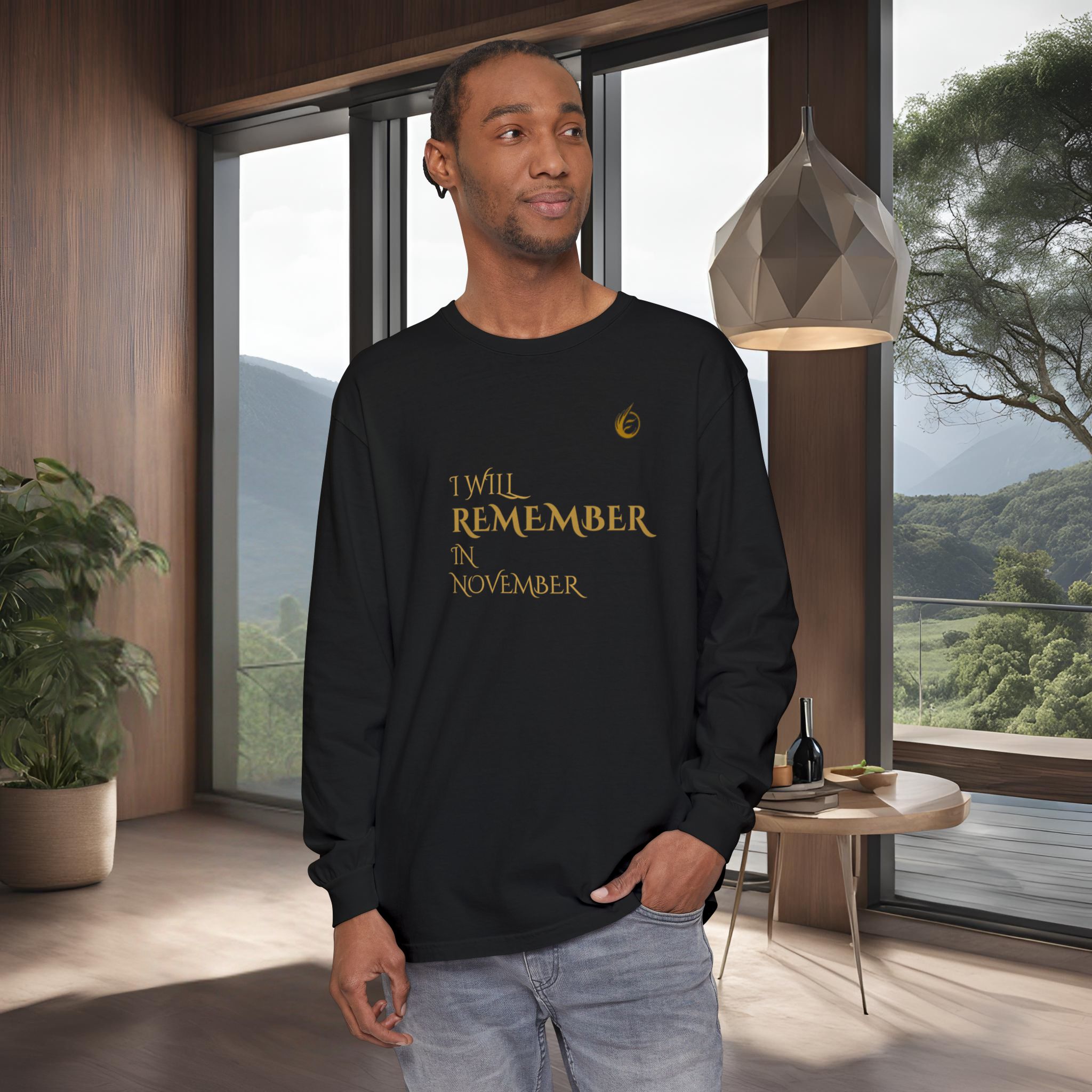 2533890360291418158_2048_customjpeg - Essence Innovation Man in a black long-sleeve shirt with gold text stands in a modern room with wooden walls and a large window showing mountains outside.