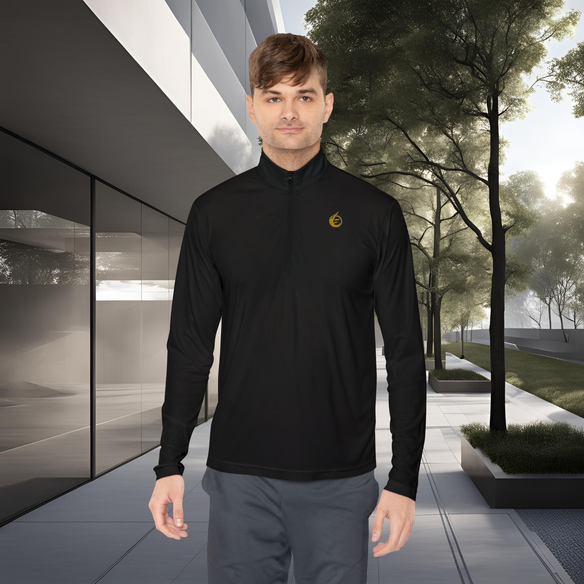 3949899034960493440_2048_customjpeg - Essence Innovation Young man in a black athletic long-sleeve top standing outdoors beside a modern glass building and trees before a park setting.