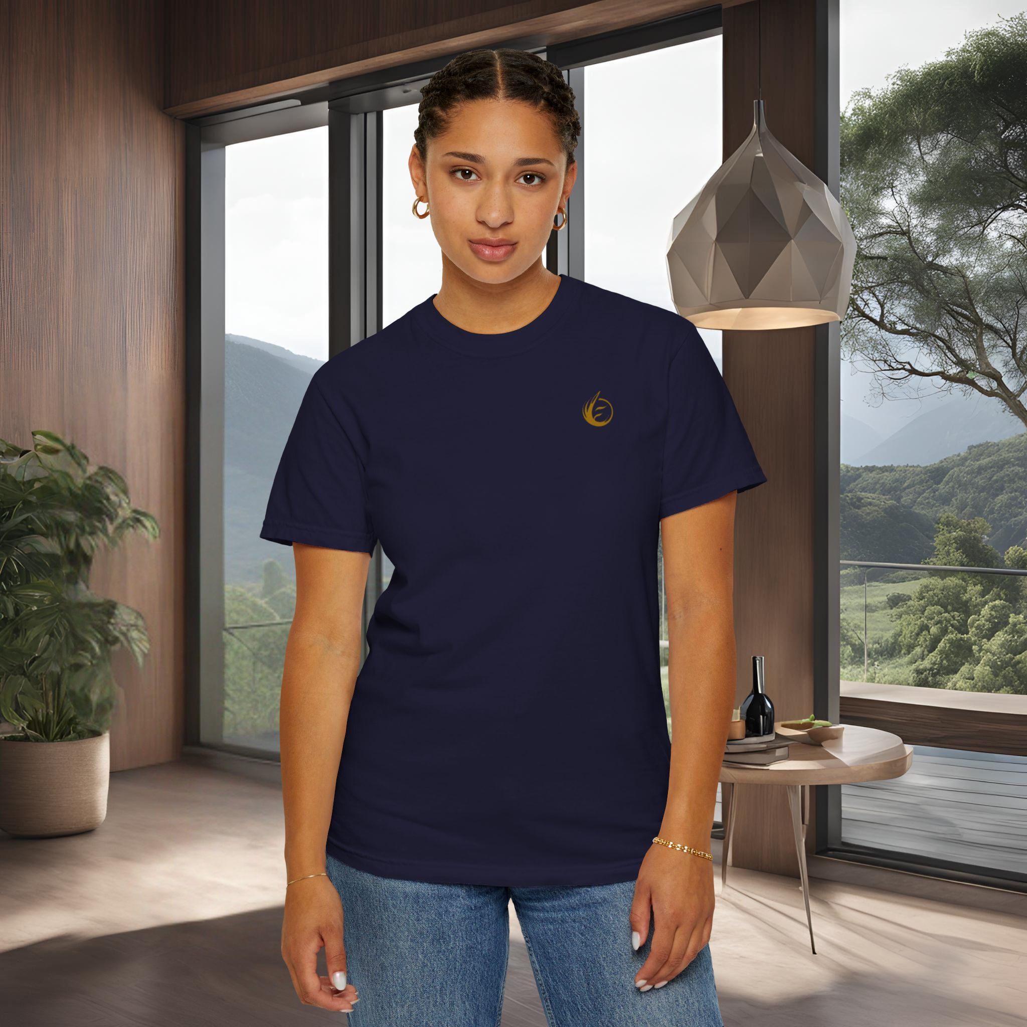 4999933851635119647_2048_customjpeg - Essence Innovation Portrait of a woman in a navy T-shirt and jeans standing in a modern room with large windows and a scenic mountain view behind her