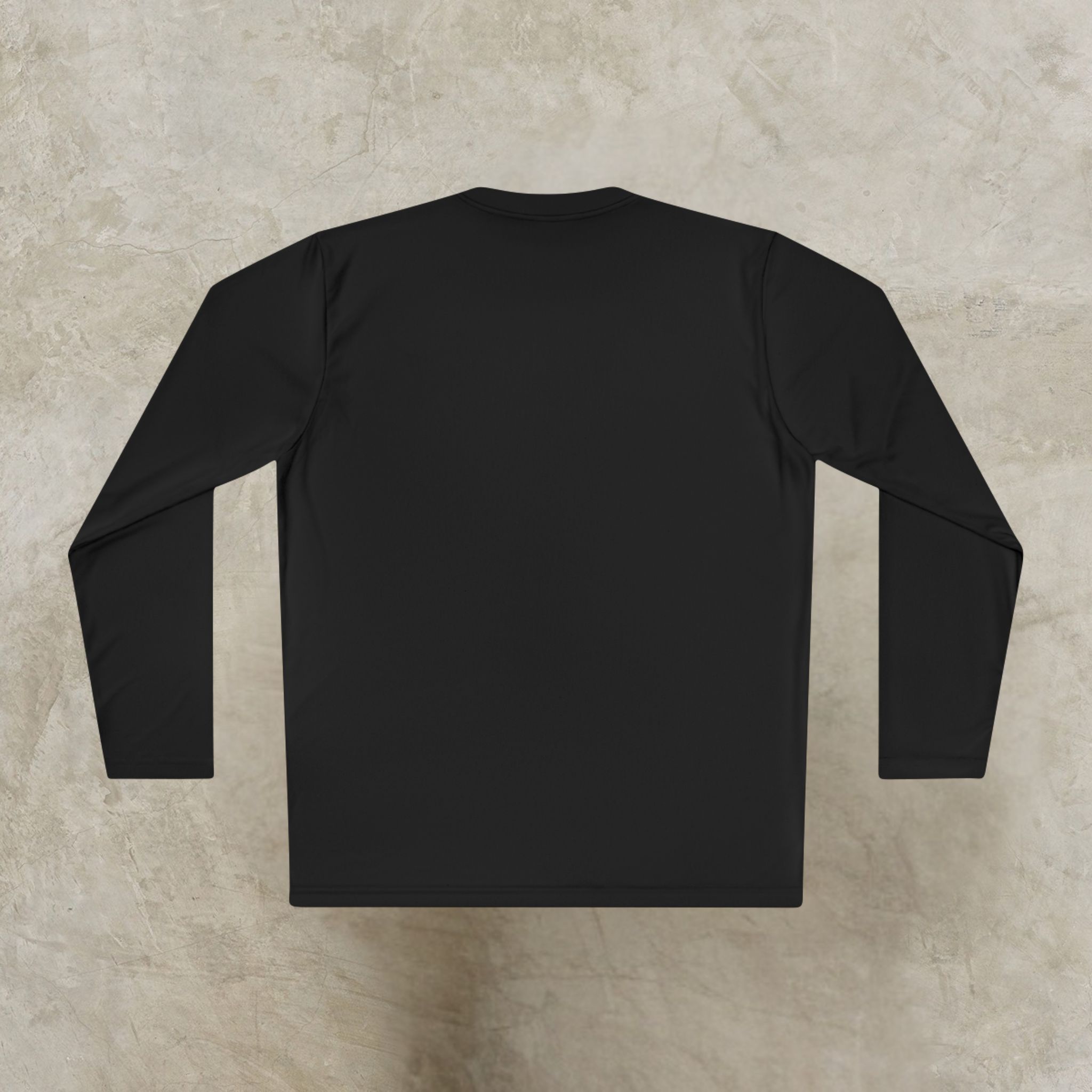 5540317916093884737_2048_customjpeg - Essence Innovation Flat lay of a black long-sleeve shirt spread out on a light textured concrete surface, viewed from above.