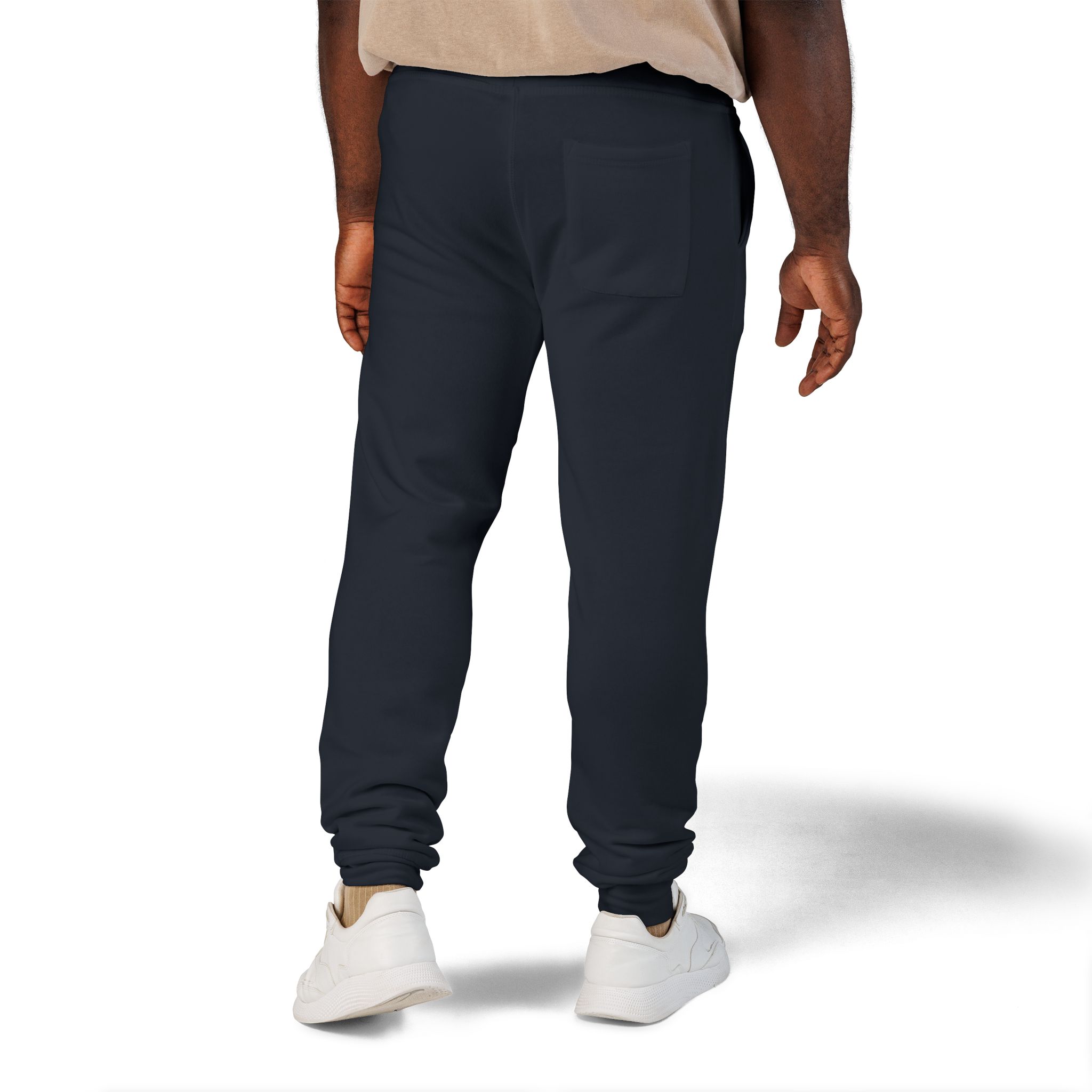 642943887519641706_2048jpeg - Essence Innovation Back view of a person wearing dark navy jogger pants with a rear pocket, beige shirt, and white sneakers.