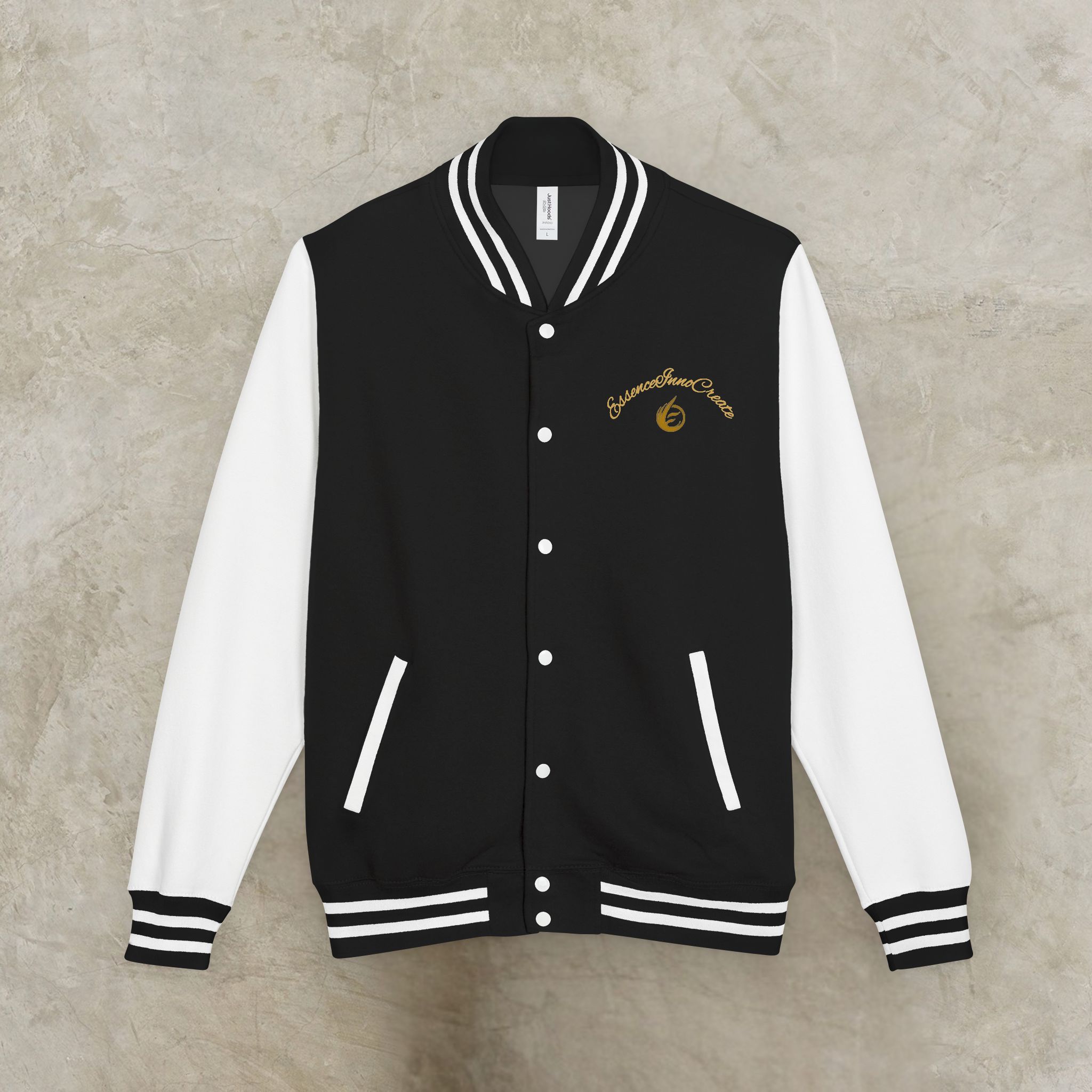 9343589181970004636_2048_customjpeg - Essence Innovation Black varsity jacket with white sleeves hung on a hanger, gold script logo on the chest.