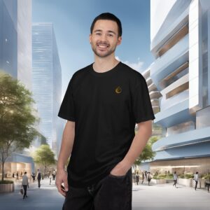 942277883906351534_2048_customjpeg - Essence Innovation Smiling man in a black T-shirt stands in a modern urban plaza with glass buildings behind him.
