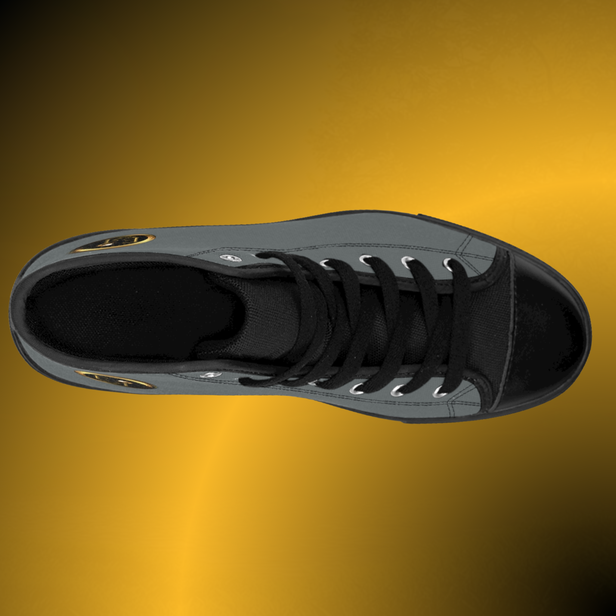 SH0056 - Essence Innovation Close-up of a black sneaker with gray detailing and laces on a gold gradient background