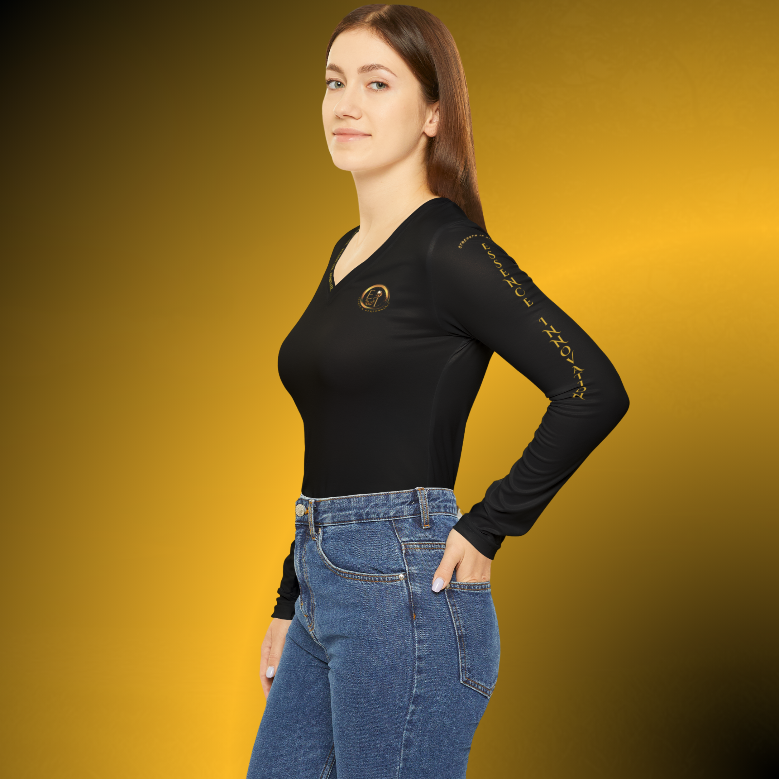 L0354 - Essence Innovation Woman posed in a black long-sleeve top and blue jeans against a gold gradient background, facing slightly to the left.